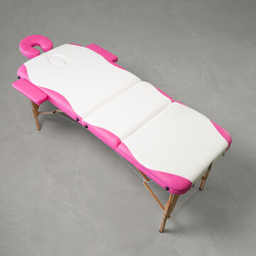 Pink and white wooden frame massage table